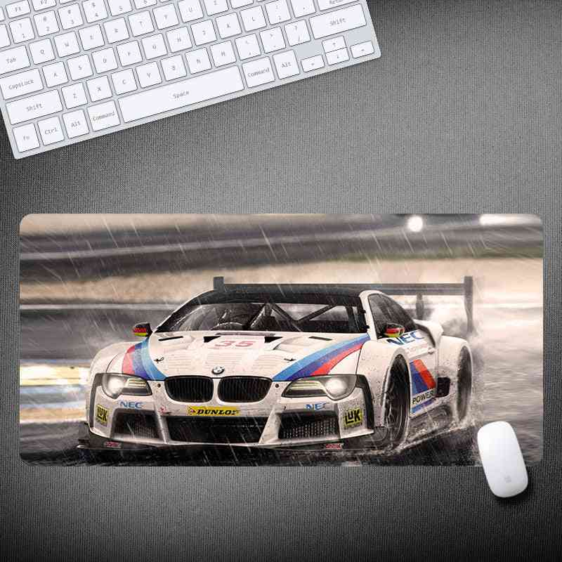 BMW racing car mouse pad with keyboard and mouse on a desk