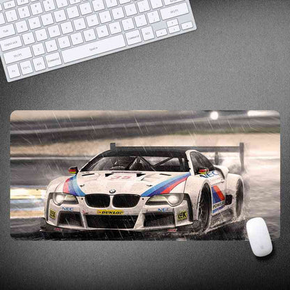 BMW racing car mouse pad with keyboard and mouse on a desk