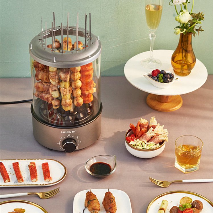 Electric skewer grill with skewered food on a table set for a meal.