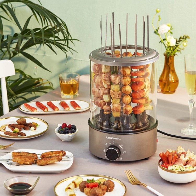 Electric skewer grill with skewered food on a dining table with plates of food and drinks.