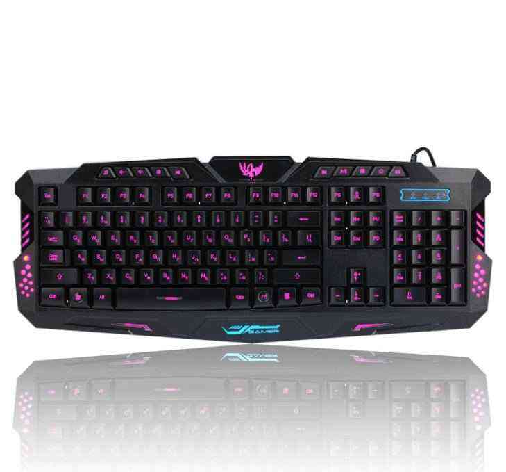 Gaming keyboard with purple backlighting on a white background