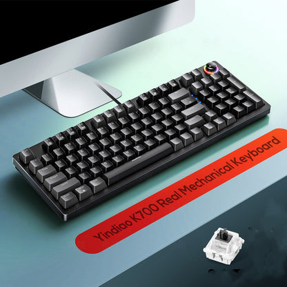 Mechanical keyboard with RGB lighting on a desk, featuring a red label indicating brand and model.