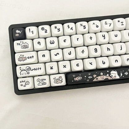 Keyboard with white keys and black keycaps featuring cartoon designs on a light gray background