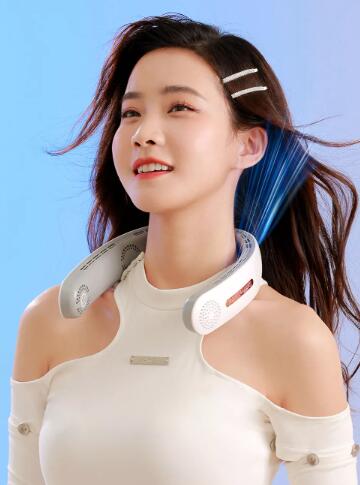 Woman wearing a neck and shoulder fan against a blue sky background
