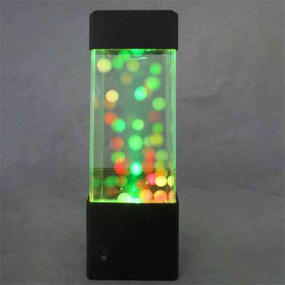 Colorful lava lamp with glowing multicolors on a dark background