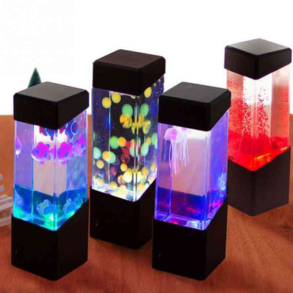 Four colorful lava lamps with LED lights on a wooden surface.