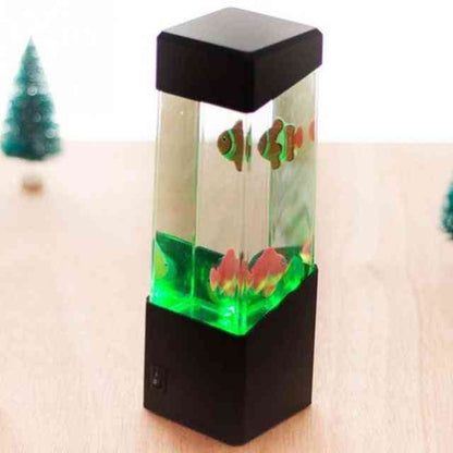 Small aquarium with fish on a wooden surface