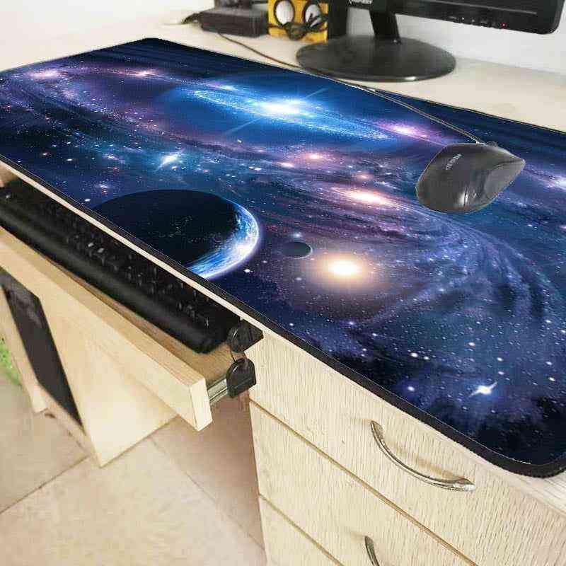 Space-themed desk mat with a keyboard and mouse on a desk