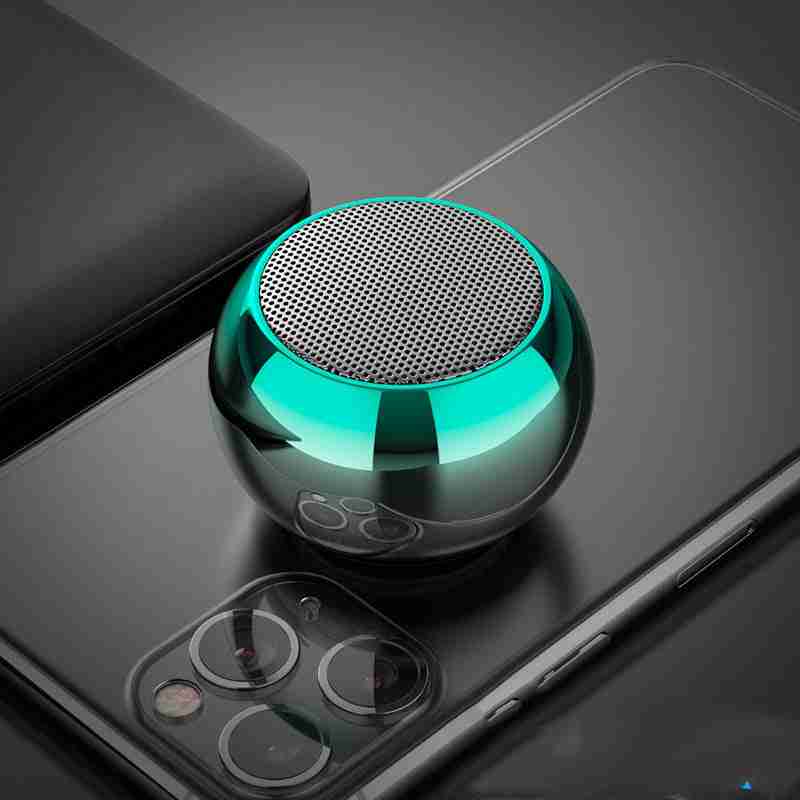 Small green metallic speaker on a smartphone