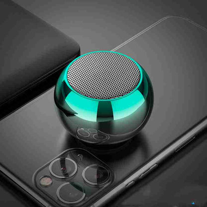 Small green metallic speaker on a smartphone