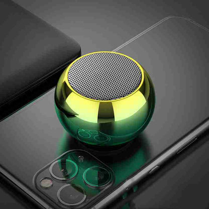 Green metallic ball-shaped object on a smartphone