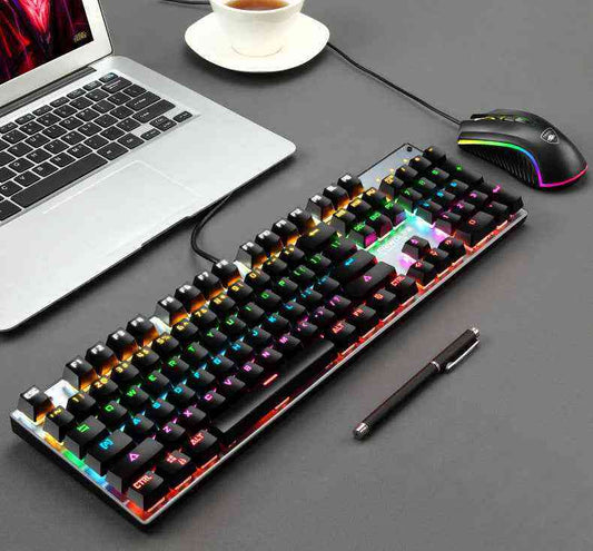 Gaming setup with keyboard, mouse, and laptop on a desk