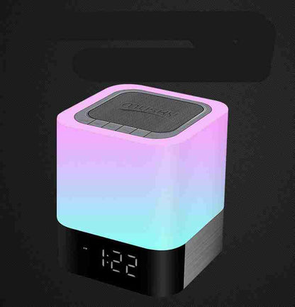 Colorful LED night light with digital clock on a black background