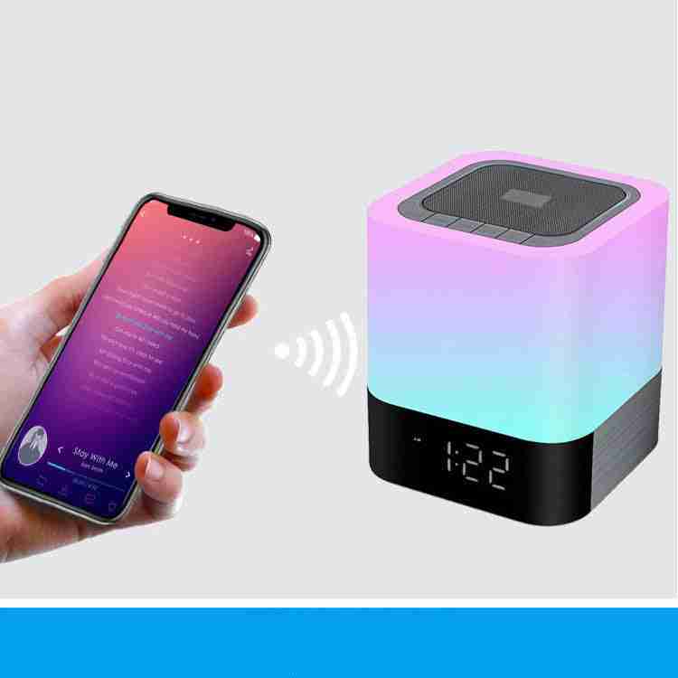 Smartphone controlling a colorful LED night light with digital display.