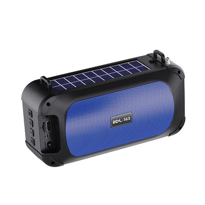 Blue portable speaker with solar panel on a white background