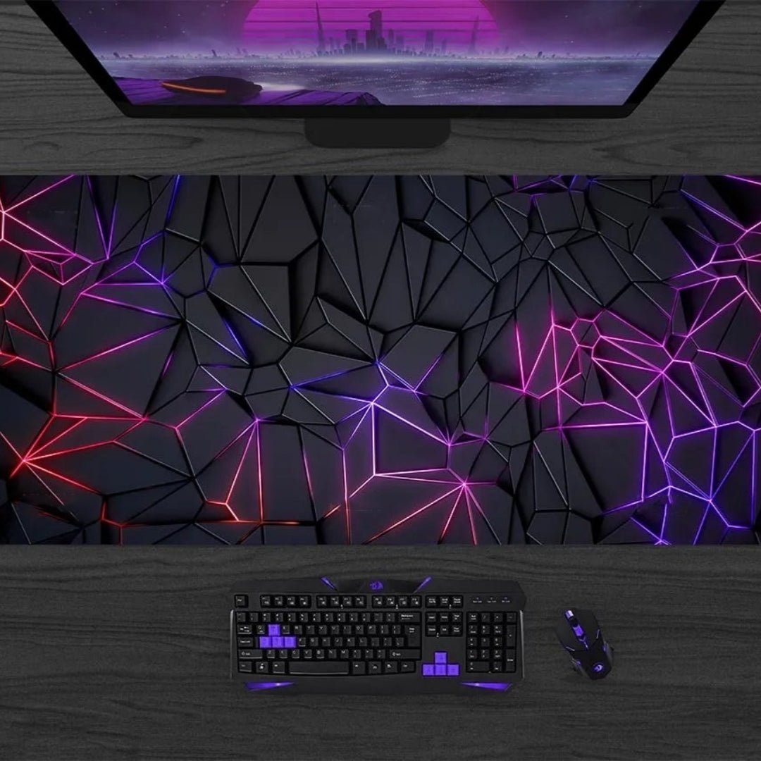 Gaming setup with keyboard, mouse, and monitor on a dark surface with geometric light pattern.