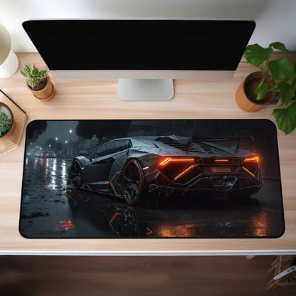 Gaming desk setup with a large mouse pad featuring a car design.