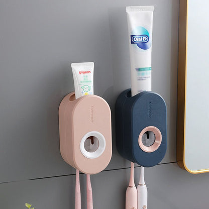Two wall-mounted toothbrush holders with toothpaste and toothbrushes on a gray wall.