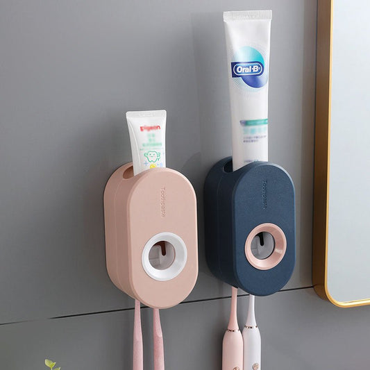Two wall-mounted toothbrush holders with toothpaste and toothbrushes on a gray wall.