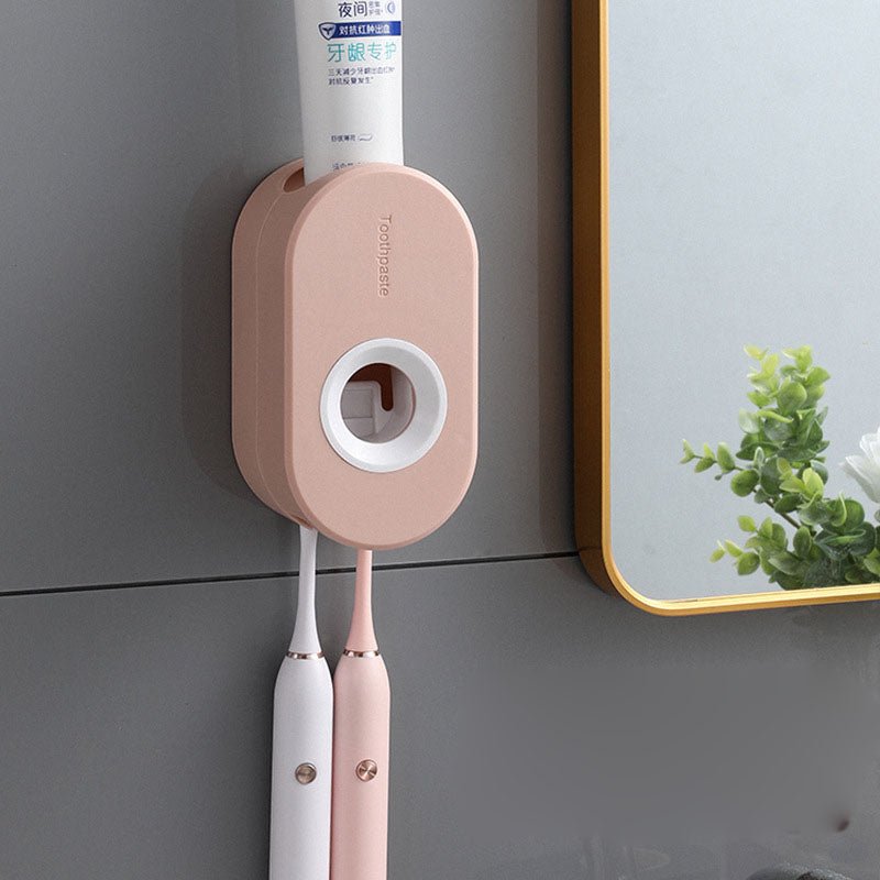 Wall-mounted toothbrush holder with toothbrushes and toothpaste on a gray wall.