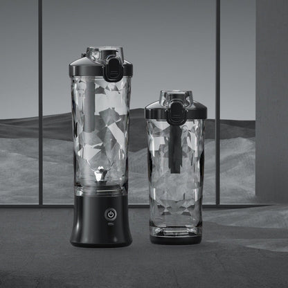 Two portable blenders with geometric patterned jars on a gray background