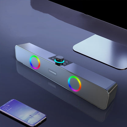 Modern soundbar with RGB lighting on a reflective surface