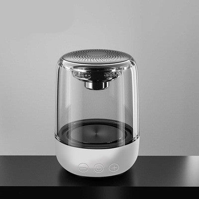 Modern glass humidifier with metallic top on a gray background