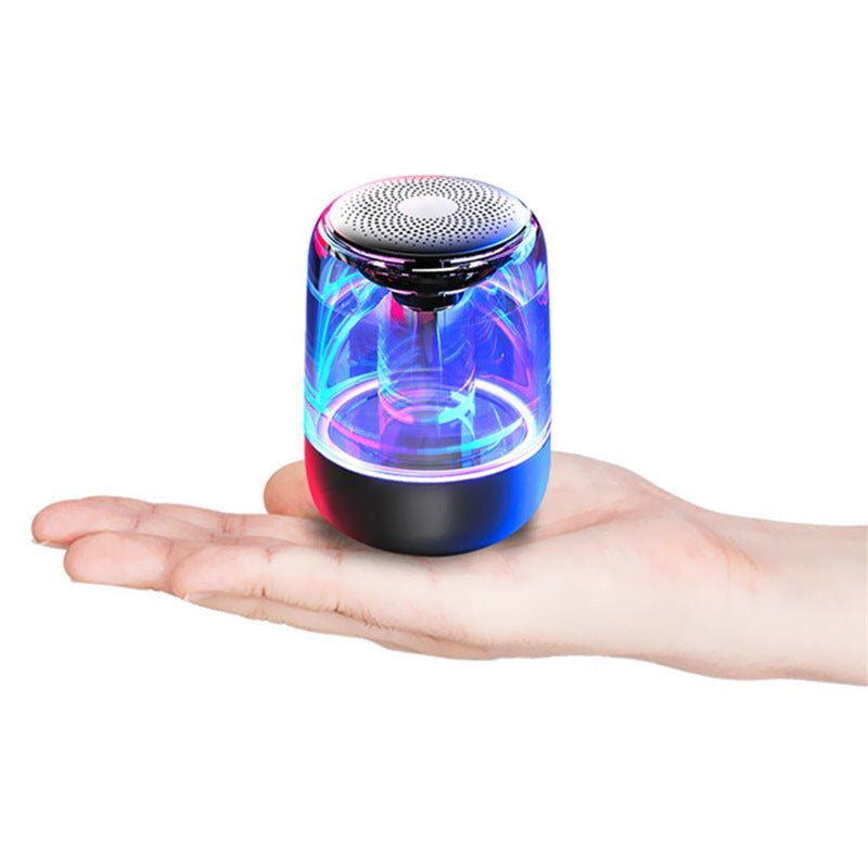Colorful LED light spinner held in a hand on a white background