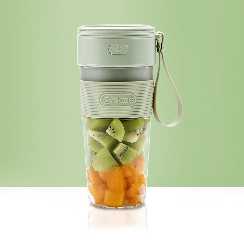 Portable blender with fruits inside on a light green background