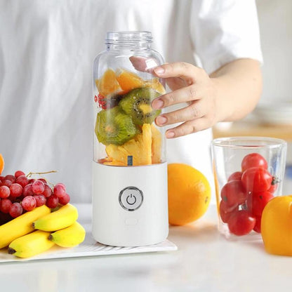 Fruit blender with fruits inside, surrounded by more fruits on a light background