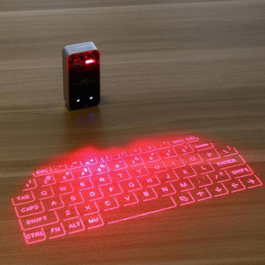 Red laser projection keyboard on a wooden surface with a small device emitting the laser.