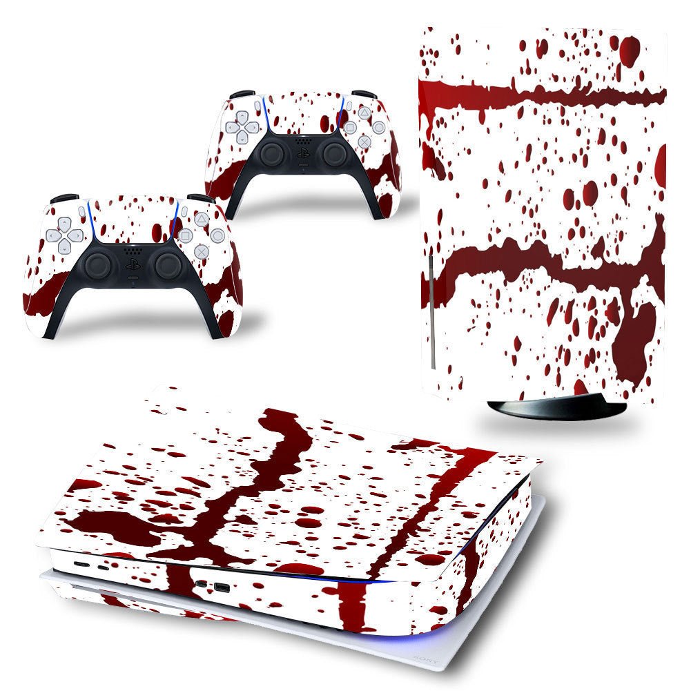 Gaming console and controllers with a blood splatter design on a white background