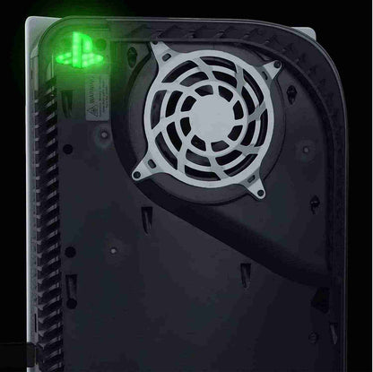 Close-up of a computer case with a cooling fan and green light on a black background