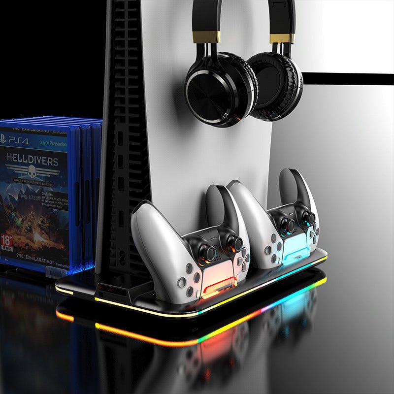 Gaming console with controllers and headphones on a stand, next to gaming console cases.