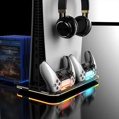 Gaming console with controllers and headphones on a stand, next to gaming console cases.
