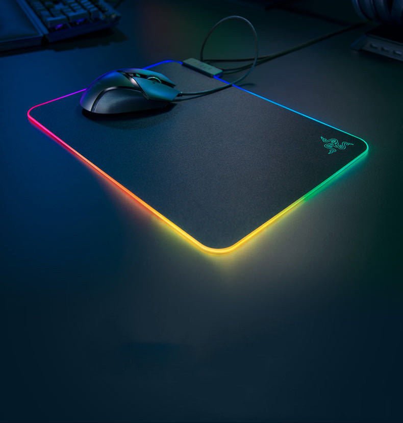 Gaming mouse pad with RGB lighting on a dark surface