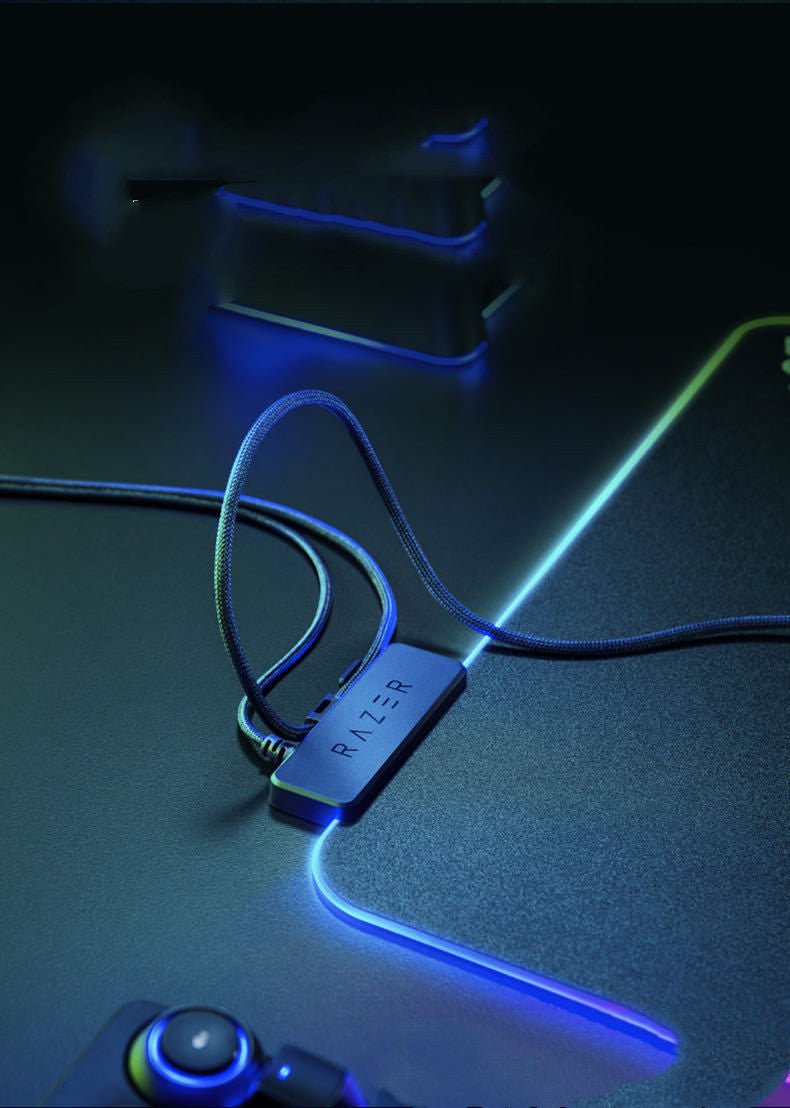 Razer USB adapter on a dark surface with glowing blue accents