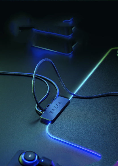 Razer USB adapter on a dark surface with glowing blue accents