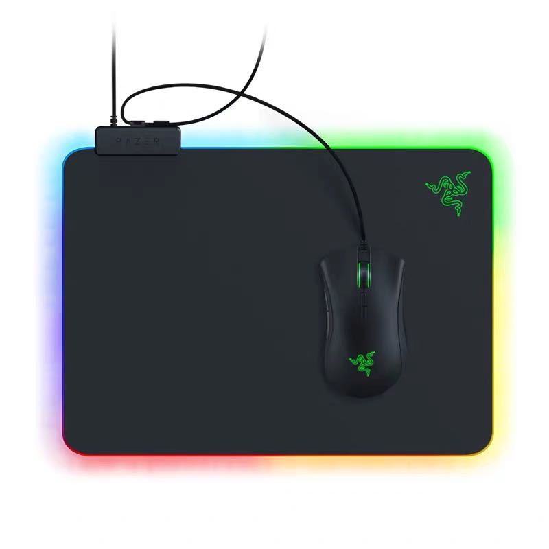 Razer gaming mouse and mouse pad with RGB lighting on a white background