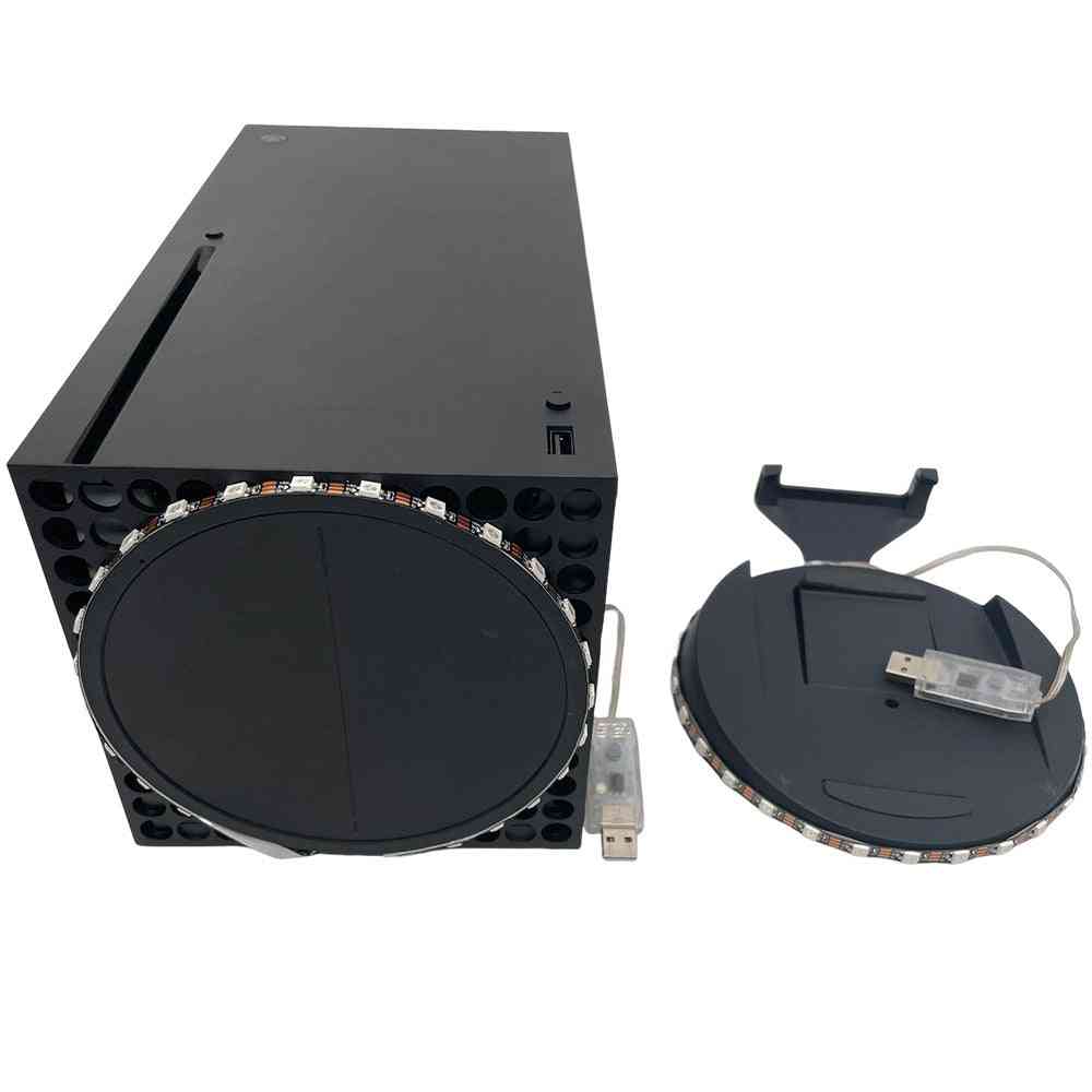 Black electronic device with a USB cable on a white background