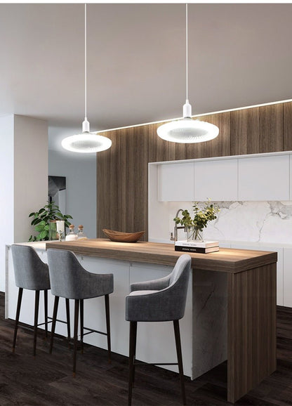Modern kitchen with wooden bar counter and gray chairs
