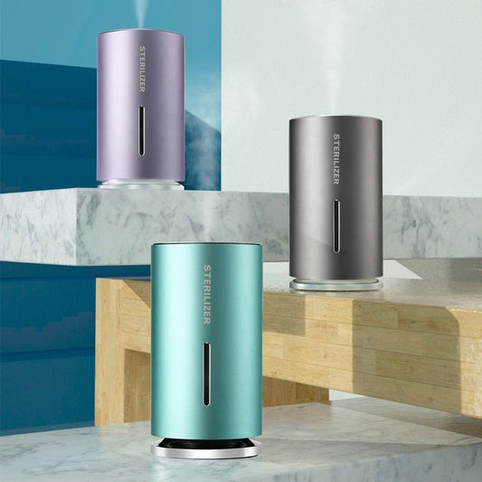 Three cylindrical sterilizers in purple, teal, and silver on a marble surface with a blue geometric background.
