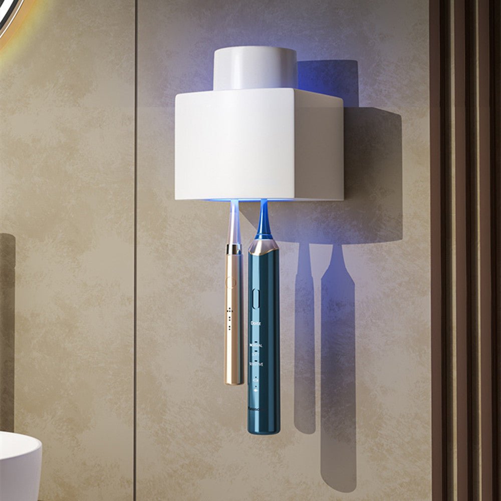 Modern wall-mounted toothbrush holder with white shade and metallic base on a textured wall.