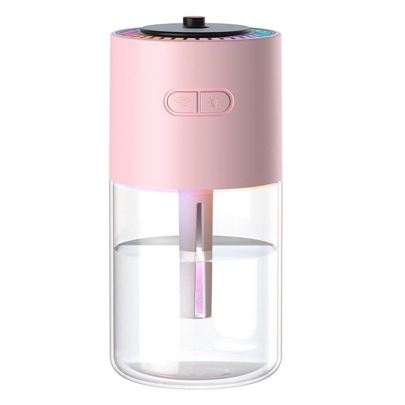 Pink and clear glass humidifier on a white background