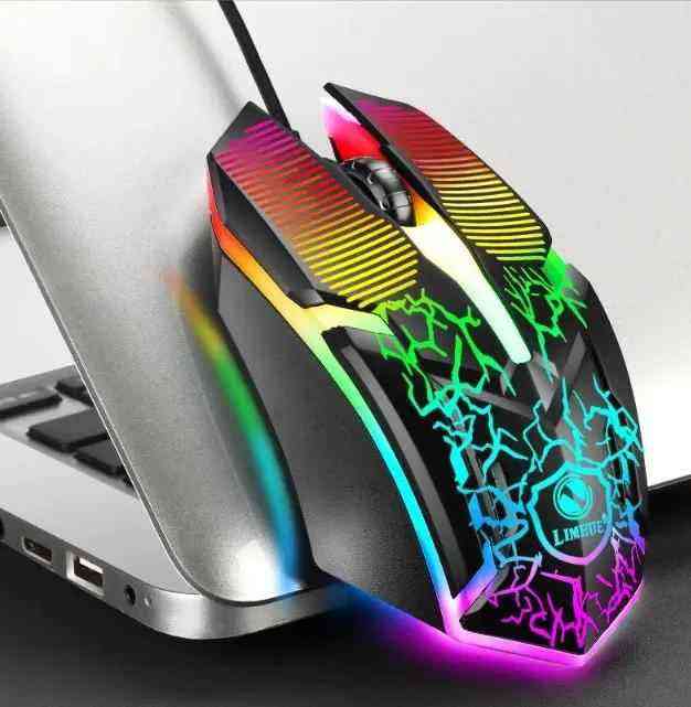 Gaming mouse with colorful LED lights next to a laptop