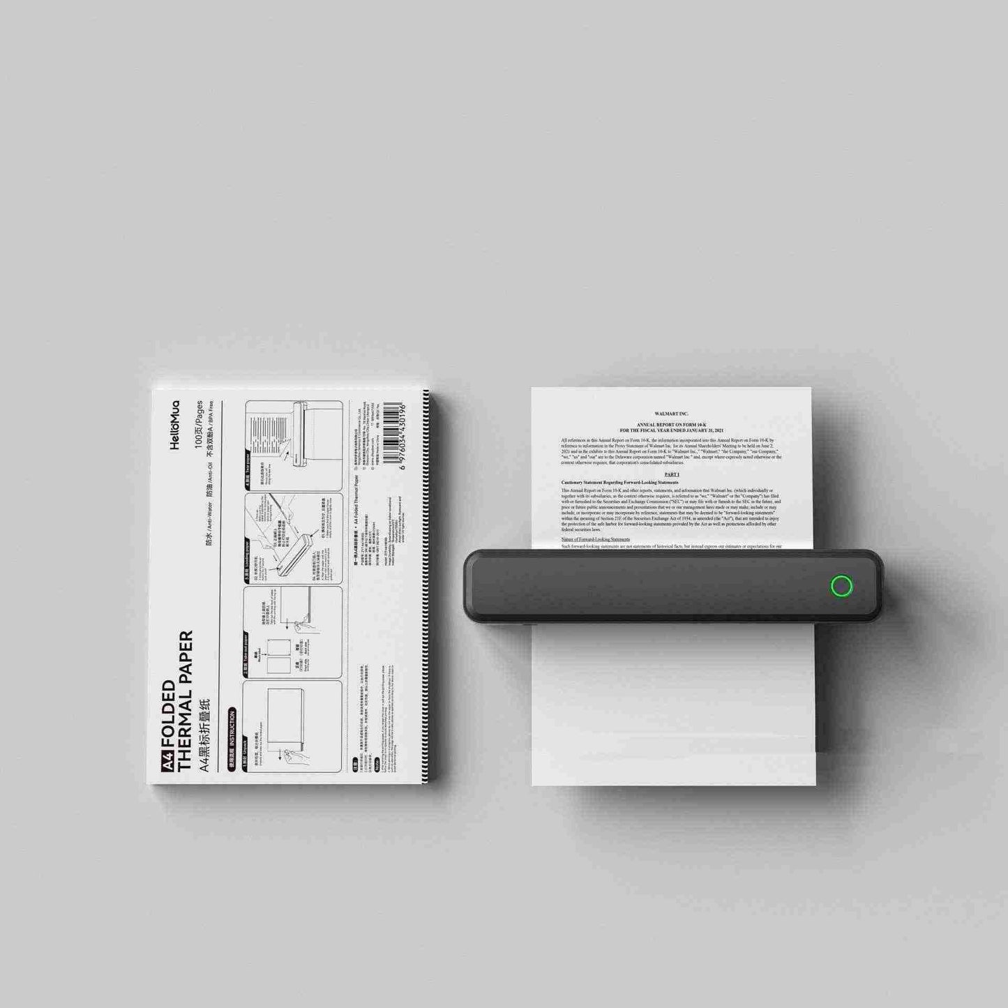 Small portable printer printing on thermal paper with a gray background