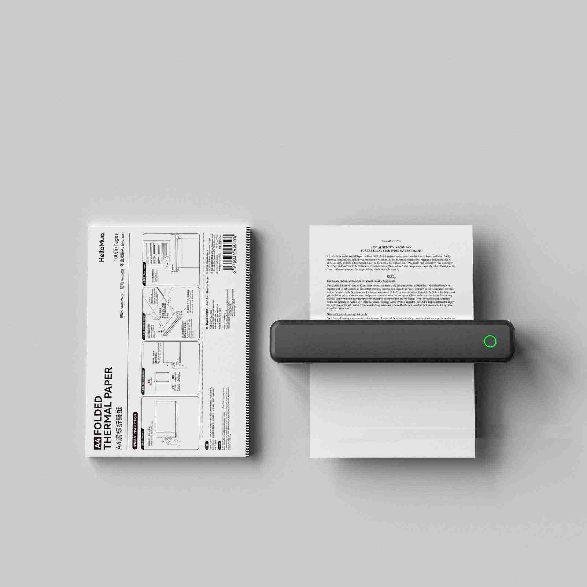 Small portable printer printing on thermal paper with a gray background