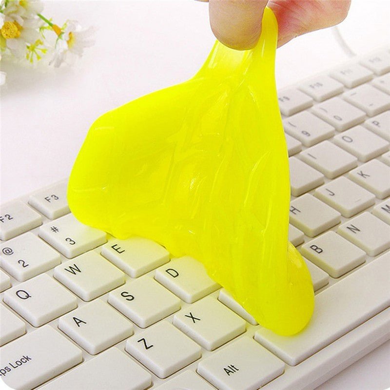 Universal Keyboard Cleaning Glue Yellow slime being stretched over a keyboard