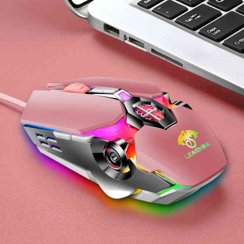 Colorful gaming mouse with RGB lighting on a pink surface next to a laptop.