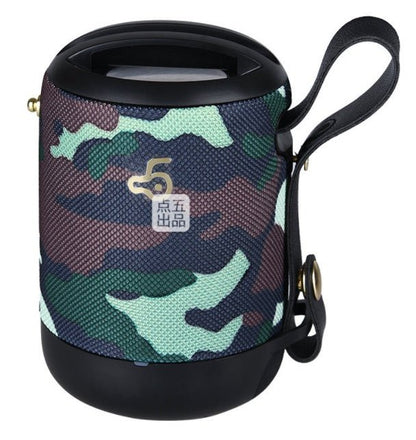 Camouflage-patterned portable speaker with a handle on a white background